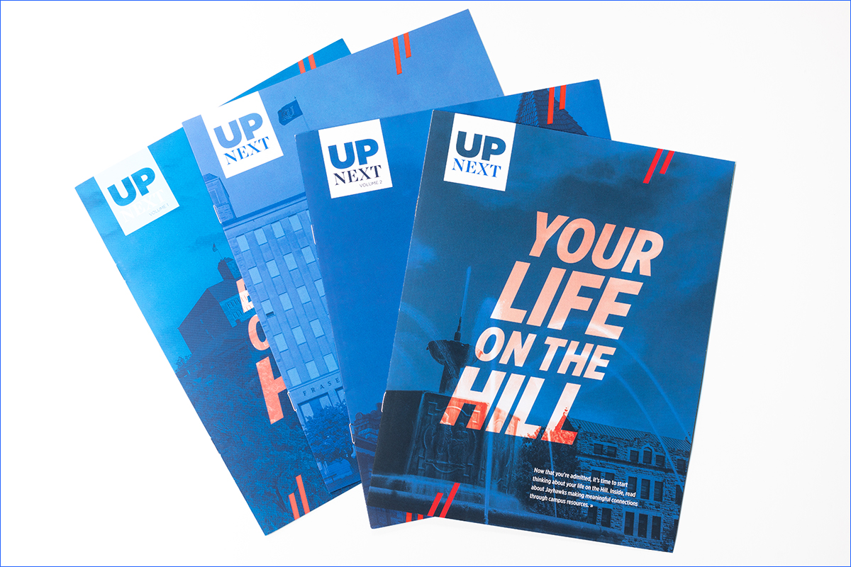 Studio photo of four overlapping magazines. The printed piece on top read, "Your life of the hill"